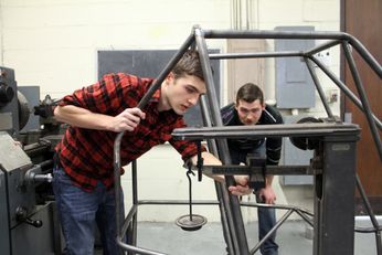 Baja SAEstudents work on a vechicle frame
